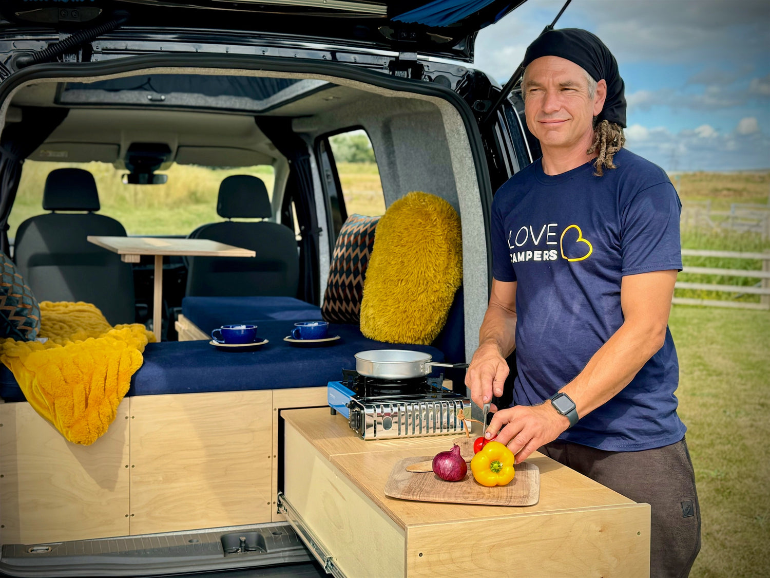 A man cuts vegetables in the Sunbox kitchen area