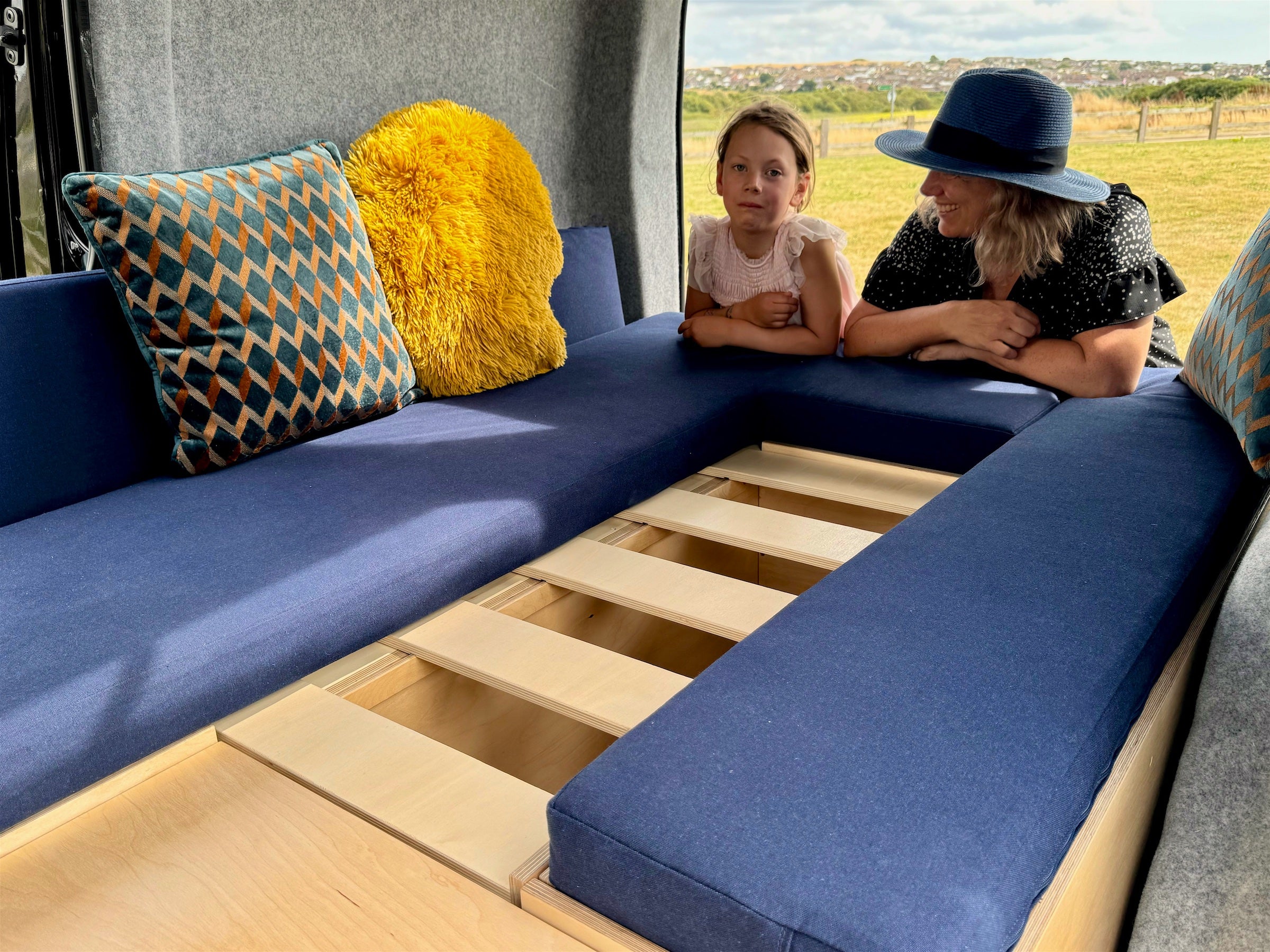 A woman and child lean on the Sunbox with the bed slats displayed