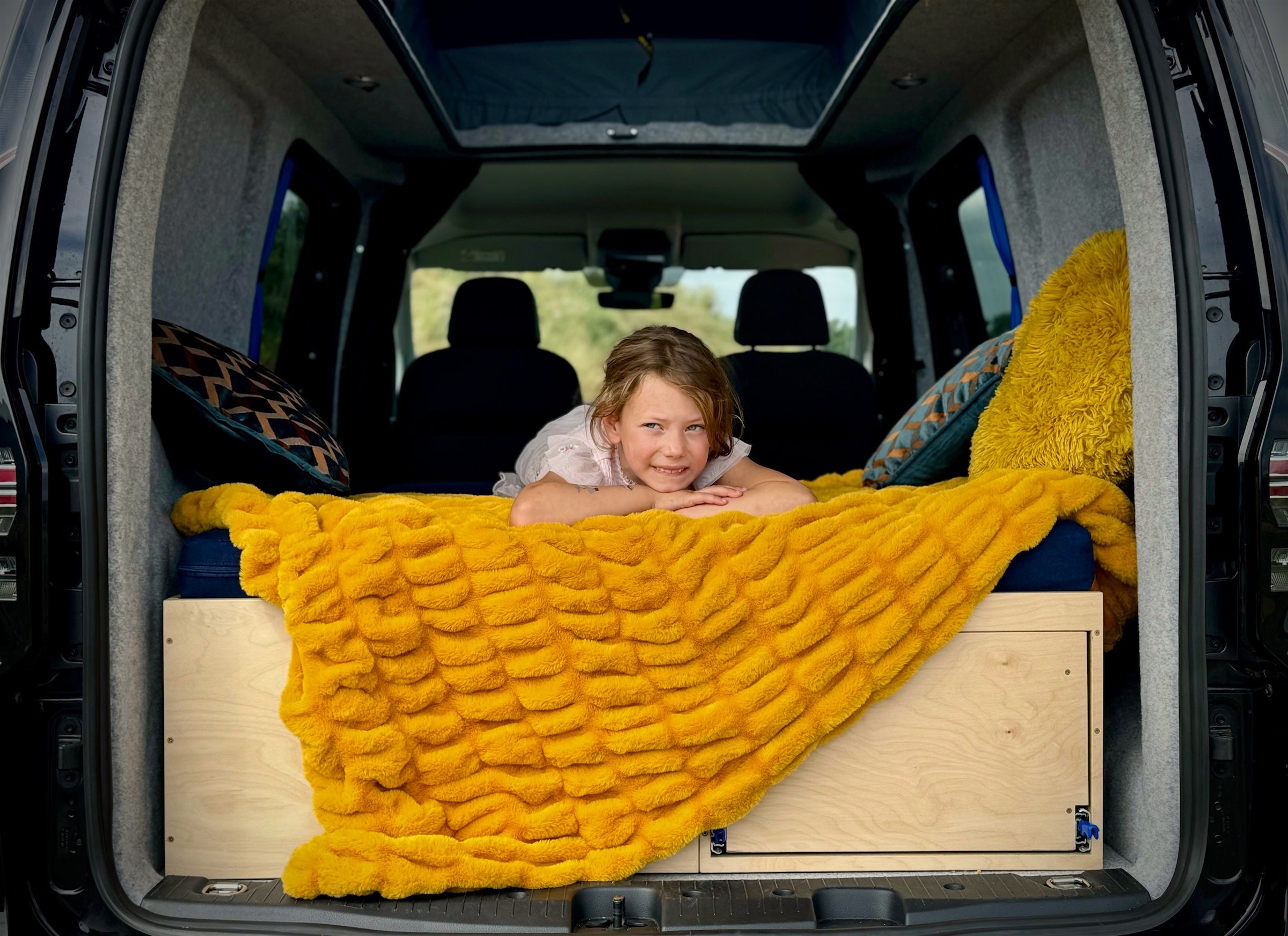 A child lounges on the Sunbox