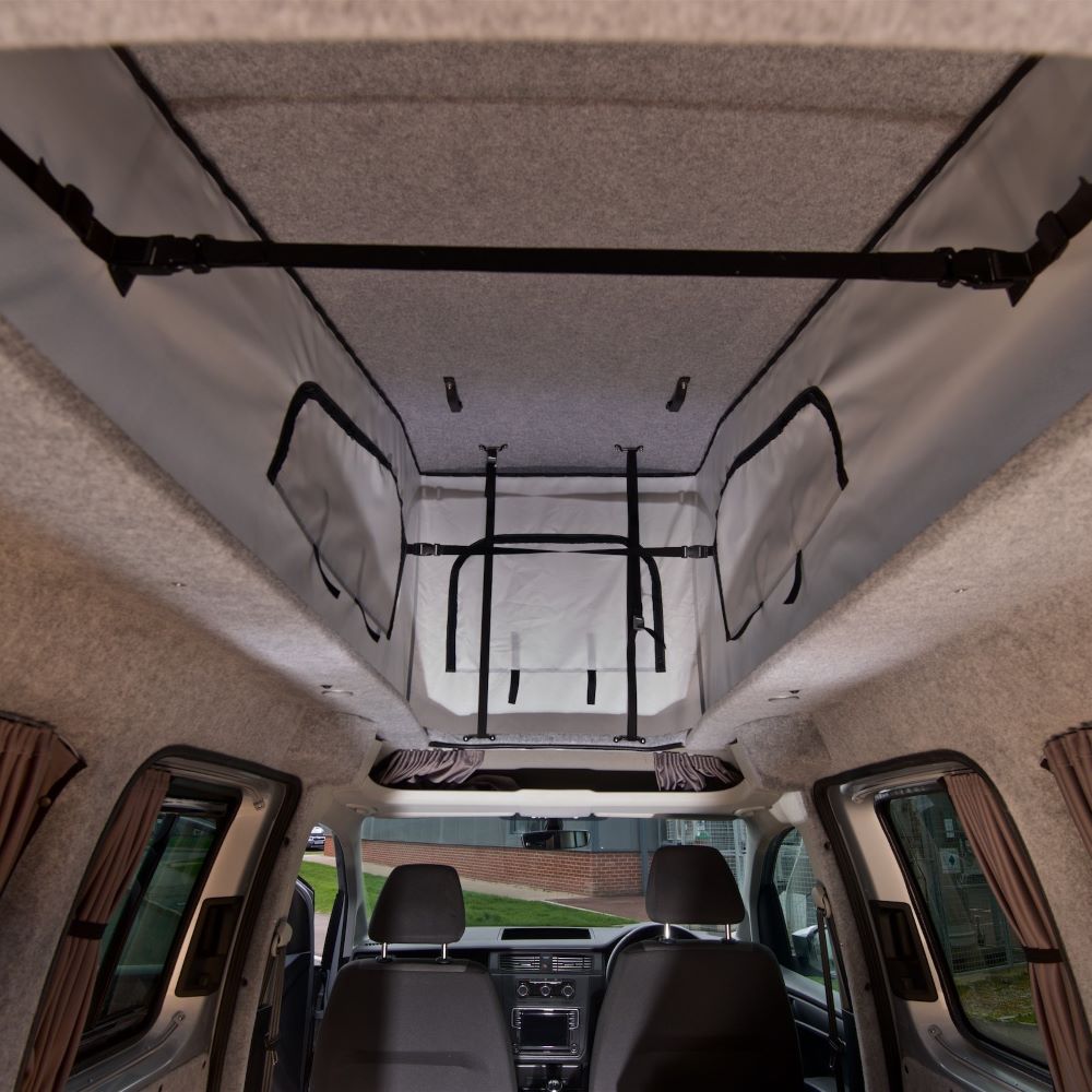 The interior of a campervan with a pop-top roof